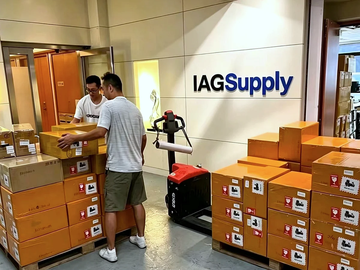 Staff stacking cartons on pallets in the IAG Supply office reception